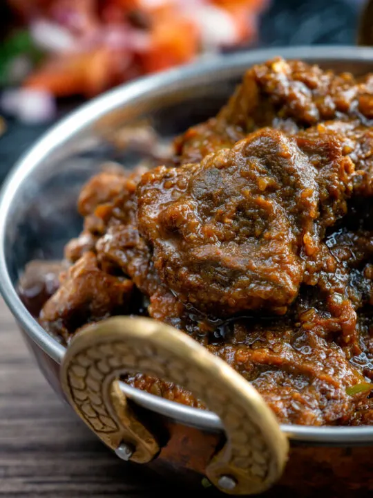 Close up hot and sour Anglo Indian pork vindaloo curry.