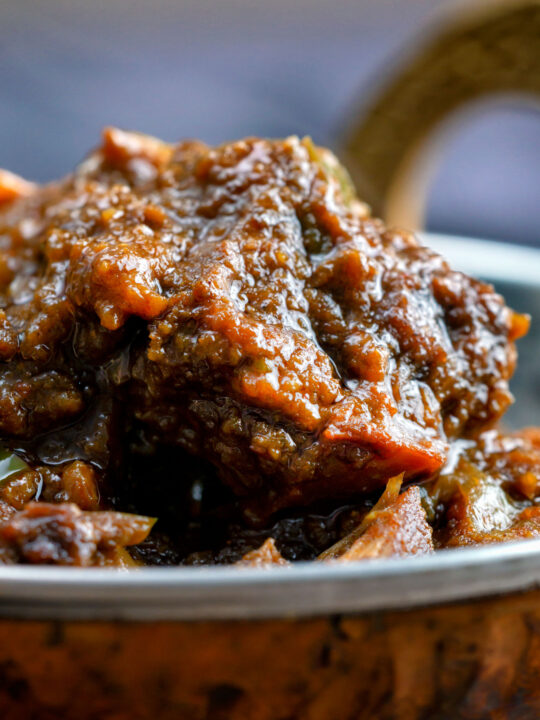 Close up hot and sour Anglo Indian pork vindaloo curry.