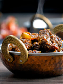 Steaming hot Anglo Goan pork vindaloo curry served in a kadai.