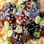 Close up easy teriyaki glazed beef meatballs with egg fried rice.