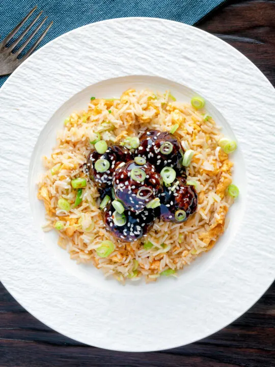 Overhead easy teriyaki glazed beef meatballs with egg fried rice.