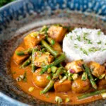 Vegan Thai massaman curry with potatoes, green beans and pistachio nuts.