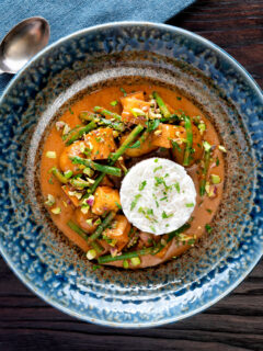 Overhead vegan Thai massaman curry with potatoes, green beans and pistachio nuts.
