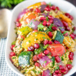Vegetarian roasted vegetable couscous salad with pomegranate arils featuring a title overlay.
