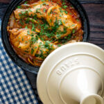 Overhead chicken tagine with preserved lemon cooked in a tagine pot.