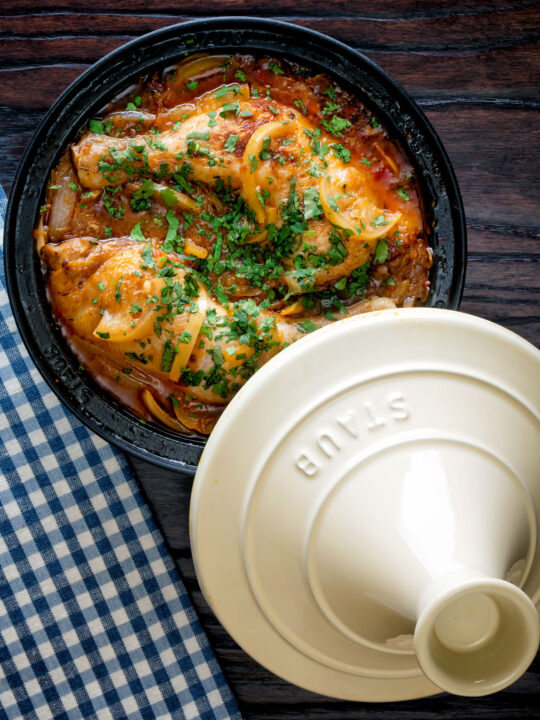 Overhead chicken tagine with preserved lemon cooked in a tagine pot.