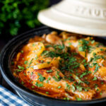 Moroccan Chicken tagine with preserved lemon cooked in a tagine pot.