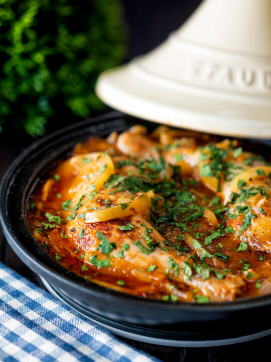 Moroccan Chicken tagine with preserved lemon cooked in a tagine pot.