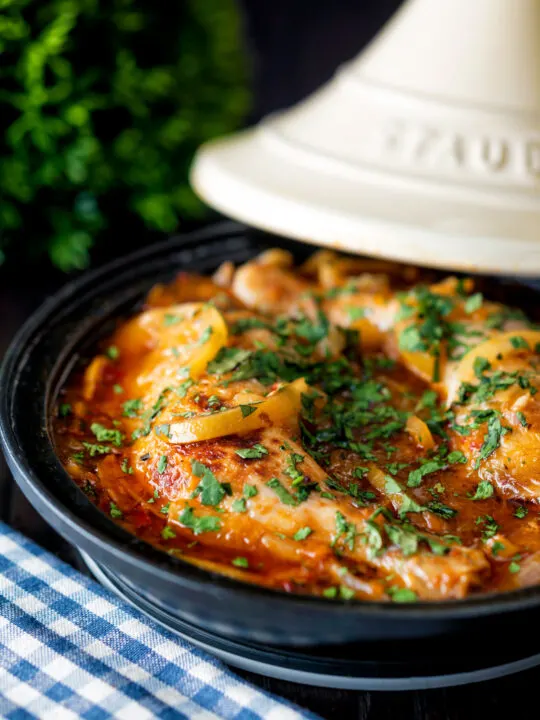 Moroccan Chicken tagine with preserved lemon cooked in a tagine pot.