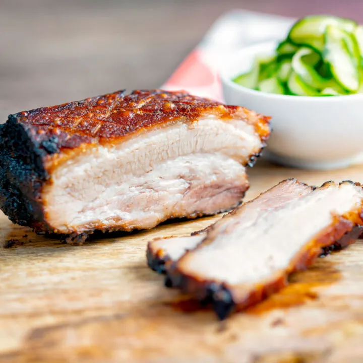 Sliced crispy Chinese Pork Belly served with pickled cucumbers.