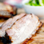 Close up sliced crispy Chinese Pork Belly featuring a title overlay.