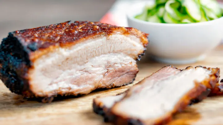 Sliced crispy Chinese Pork Belly served with pickled cucumbers.