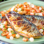 Devilled mackerel fillets served with a pickled onion and tomato salad.