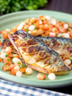 Devilled mackerel fillets served with a pickled onion and tomato salad.