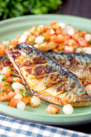 Devilled mackerel fillets served with a pickled onion and tomato salad.