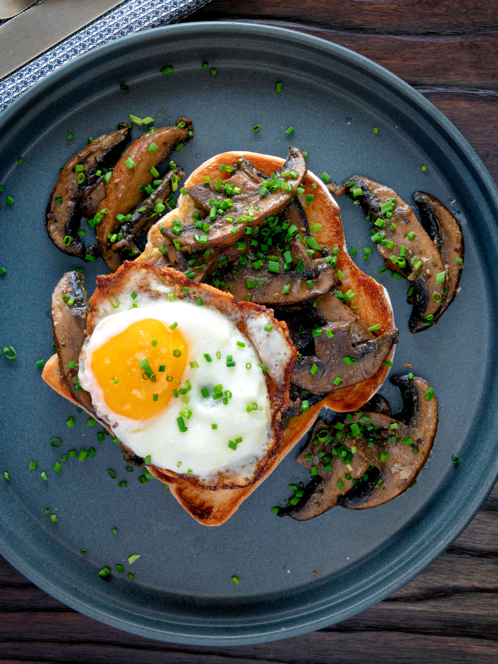 Overhead devilled mushrooms on toast with a fried egg.