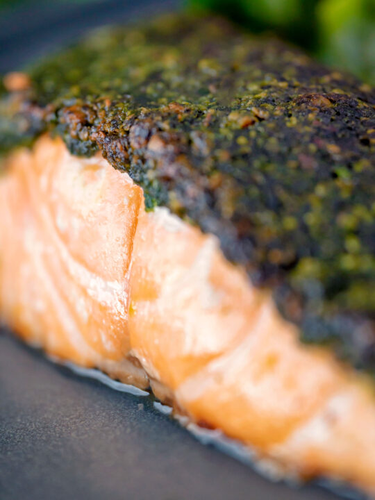 Close up baked herb crusted salmon fillet.