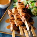 Pork satay skewers with peanut dipping sauce.