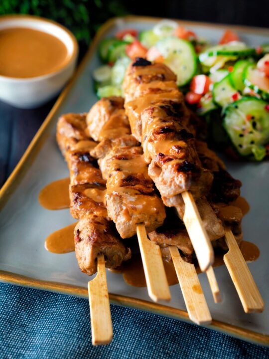 Pork satay skewers with peanut dipping sauce.