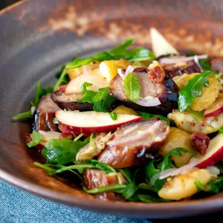 Sausage salad with apple, new potatoes and bacon in a maple and mustard dressing.