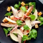 Overhead smoked mackerel salad with apple, bacon and croutons featuring a title overlay.
