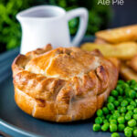 Hand raised steak and ale pie with chips and peas with a title overlay.