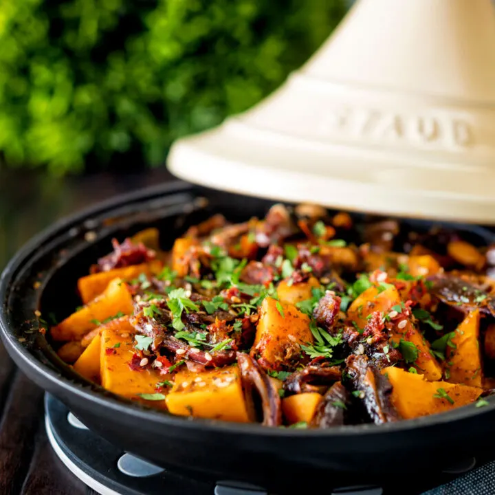 Vegan sweet potato tagine with dates and almonds in a harissa sauce.