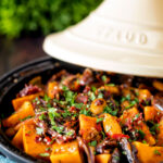Sweet potato tagine with dates and almonds served in a tagine pot.