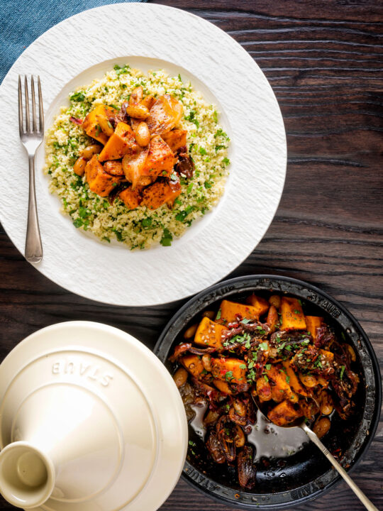 Overhead sweet potato tagine with dates and almonds served with buttered couscous.