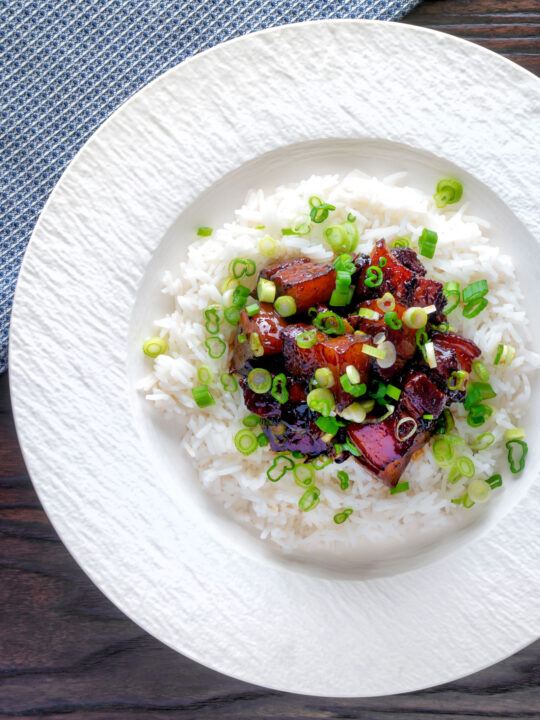 Overhead Vietnamese pork belly influenced by thit ba chi kho served with rice.