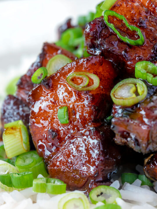 Close up Vietnamese pork belly influenced by thit ba chi kho served with rice.