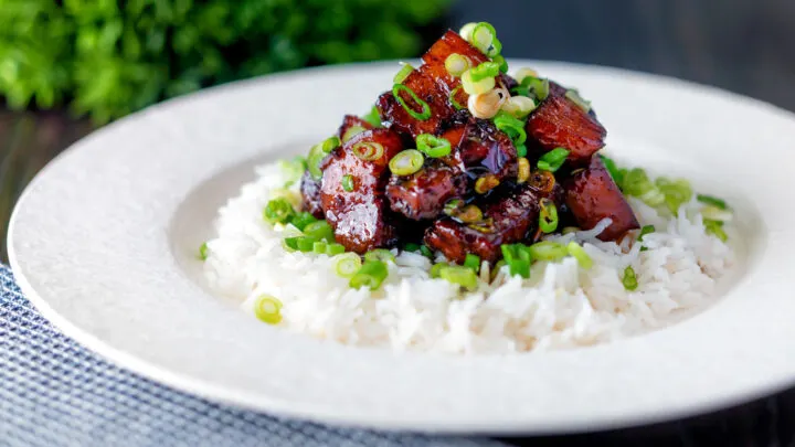 Vietnamese pork belly influenced by thit ba chi kho served with rice and spring onion.