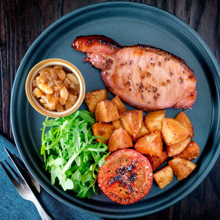 Cider glazed bacon chops with fried potatoes, grilled tomato, rocket and apple chutney.