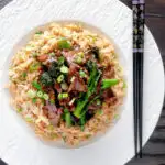 Overhead beef and broccoli stir fry served with egg fried rice featuring a title overlay.