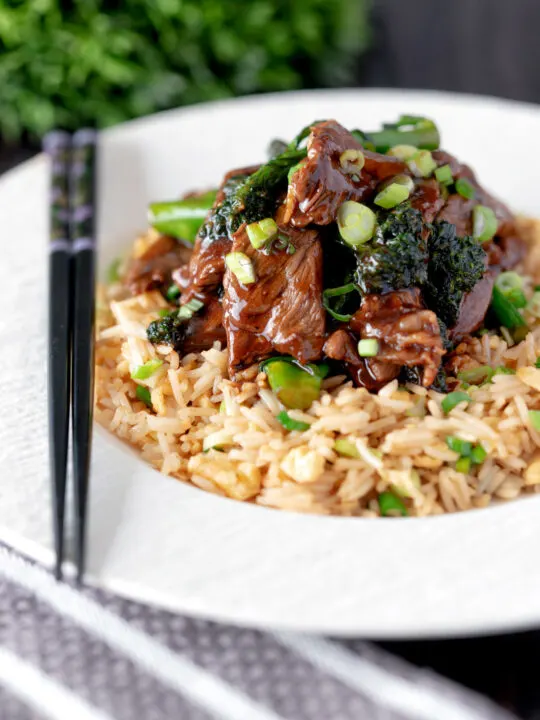 Beef and broccoli stir fry served with egg fried rice.