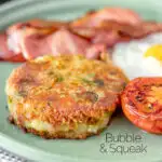 Fried bubble and squeak patty served with bacon, grilled tomato and fried egg Featuring a title overlay.