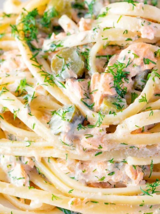 Close up tinned salmon pasta with creme fraiche, cornichons and fresh dill.