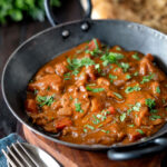 Chicken balti curry served in and iron karahi with fresh coriander.