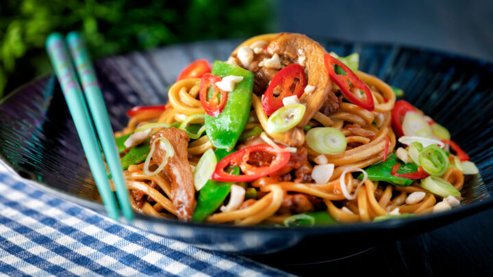 Chicken satay stir fry with peanuts, mangetout and egg noodles.