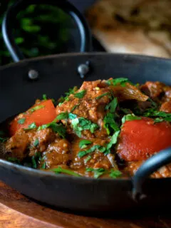 Indian influenced lamb jalfrezi curry garnished with fresh coriander.