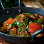 Indian influenced lamb jalfrezi curry garnished with fresh coriander featuring a title overlay.