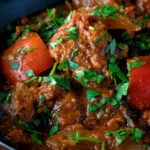 Close up Indian influenced lamb jalfrezi curry garnished with fresh coriander.
