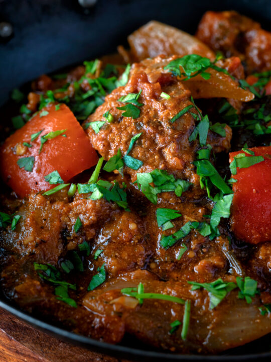 Close up Indian influenced lamb jalfrezi curry garnished with fresh coriander.