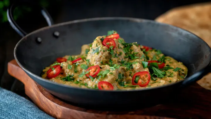 Indian influenced lamb pasanda almond and yoghurt curry garnished with fresh chilli and coriander.