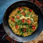Overhead Indian influenced lamb pasanda curry.