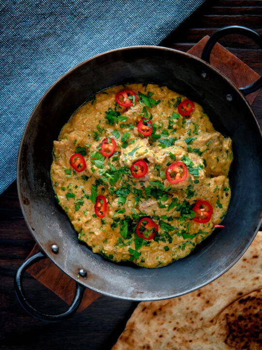 Overhead Indian influenced lamb pasanda curry.