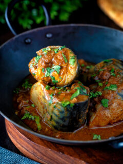 Indian influenced mackerel curry served in a karai.