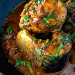 Close up Indian influenced mackerel curry served in a karai.