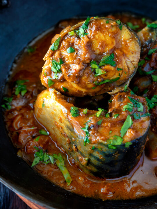 Close up Indian influenced mackerel curry served in a karai.