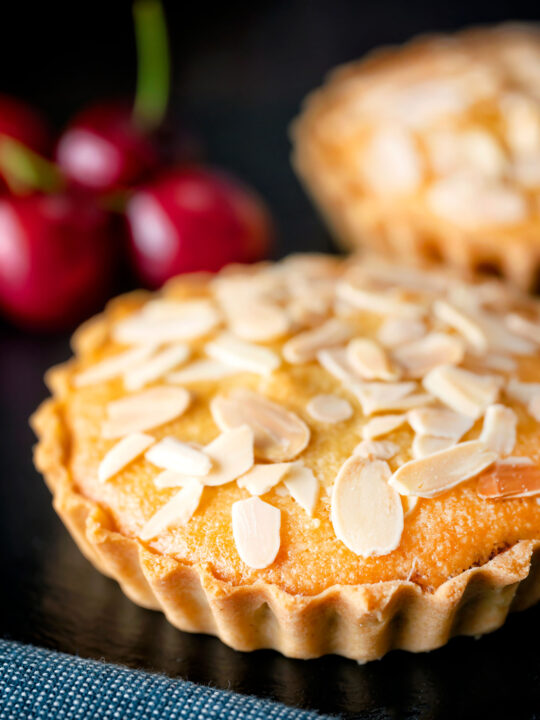 Mini Bakewell tarts with a frangipane filling and almond topping.